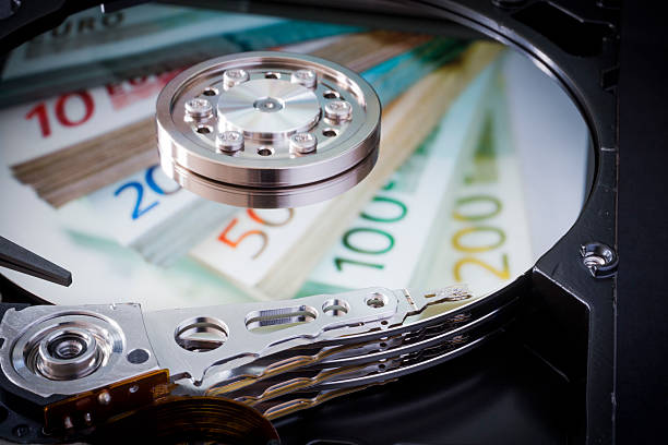 BERLIN, GERMANY - JANUARY 29: Symbolic photo for data protection, reflection of euro bills in a computer hard drive on January 29, 2015 in Berlin, Germany. (Photo by Thomas Trutschel/Photothek via Getty Images)